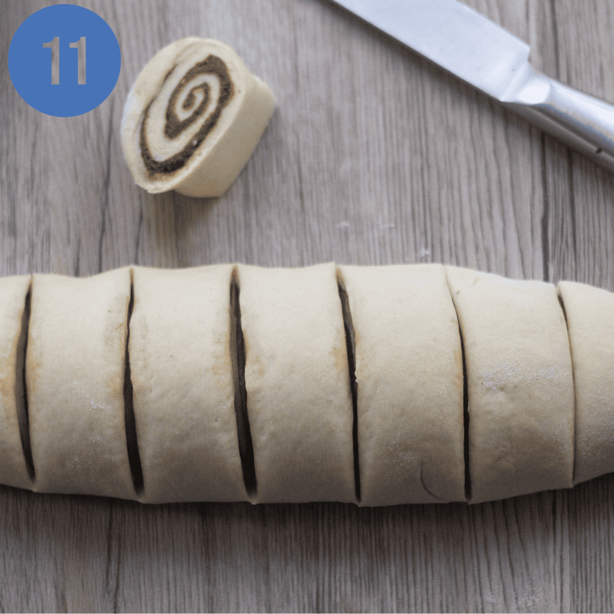 Cutting the cinnamon rolls into the rolls.
